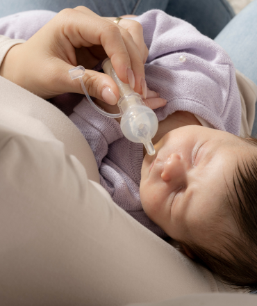 baby drinking from colostrum